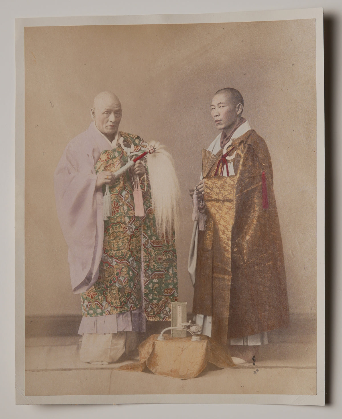 Buddhist Priests, hand-colored Meiji albumen print: two priests in brocade kesa