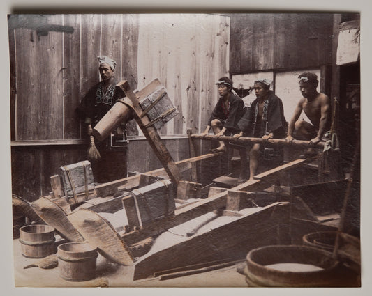 Pounding Rice, hand-colored albumen print attributed to Kusakabe Kimbei: workers at treadle pestles